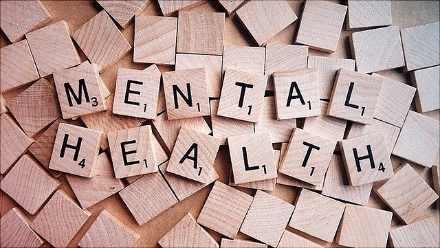 Small wooden cubes with letters forming the words "mental health"