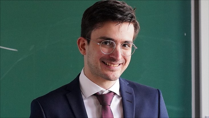 Man with glasses wearing a suit