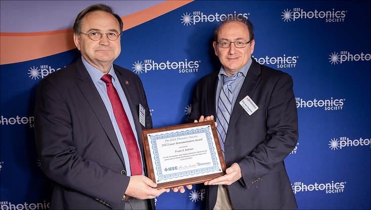 Two men holding a certificate