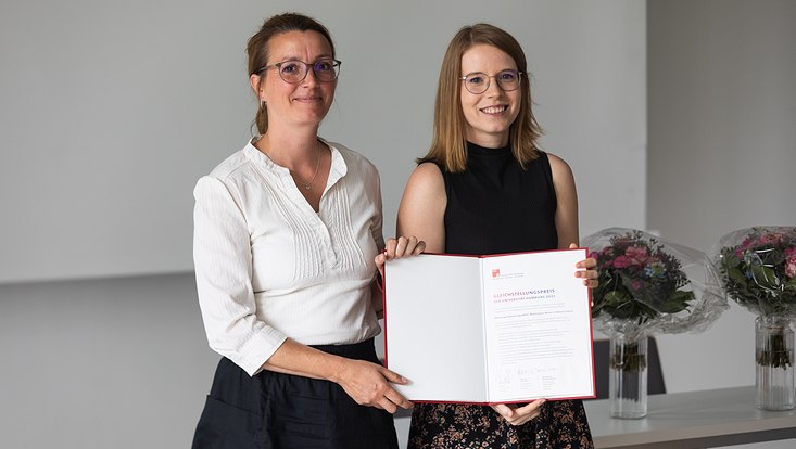 Two women holding a certificate